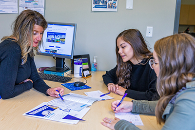 Two students meeting with an Admissions advisor