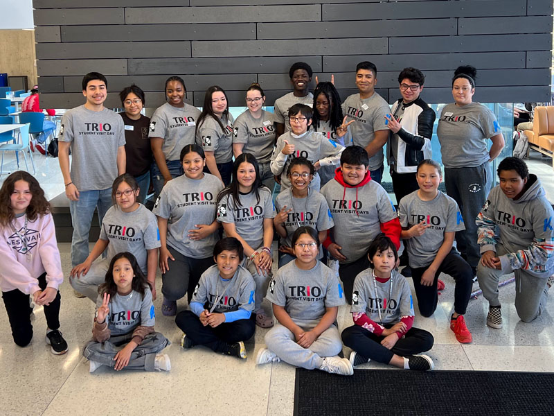 Group of middle school students from Meskwaki Settlement pose in Iowa Hall on Main Campus